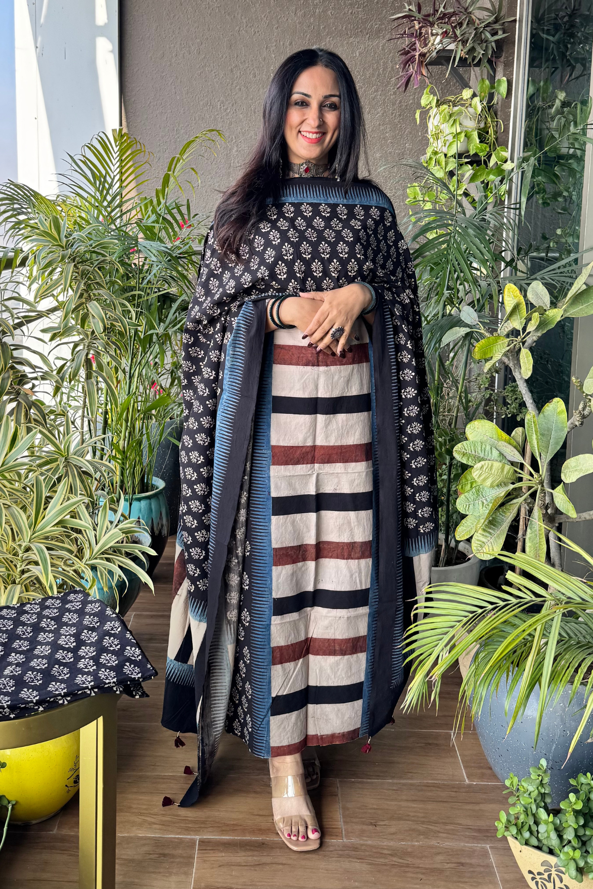 Black color suit with horizontal stripes on shirt