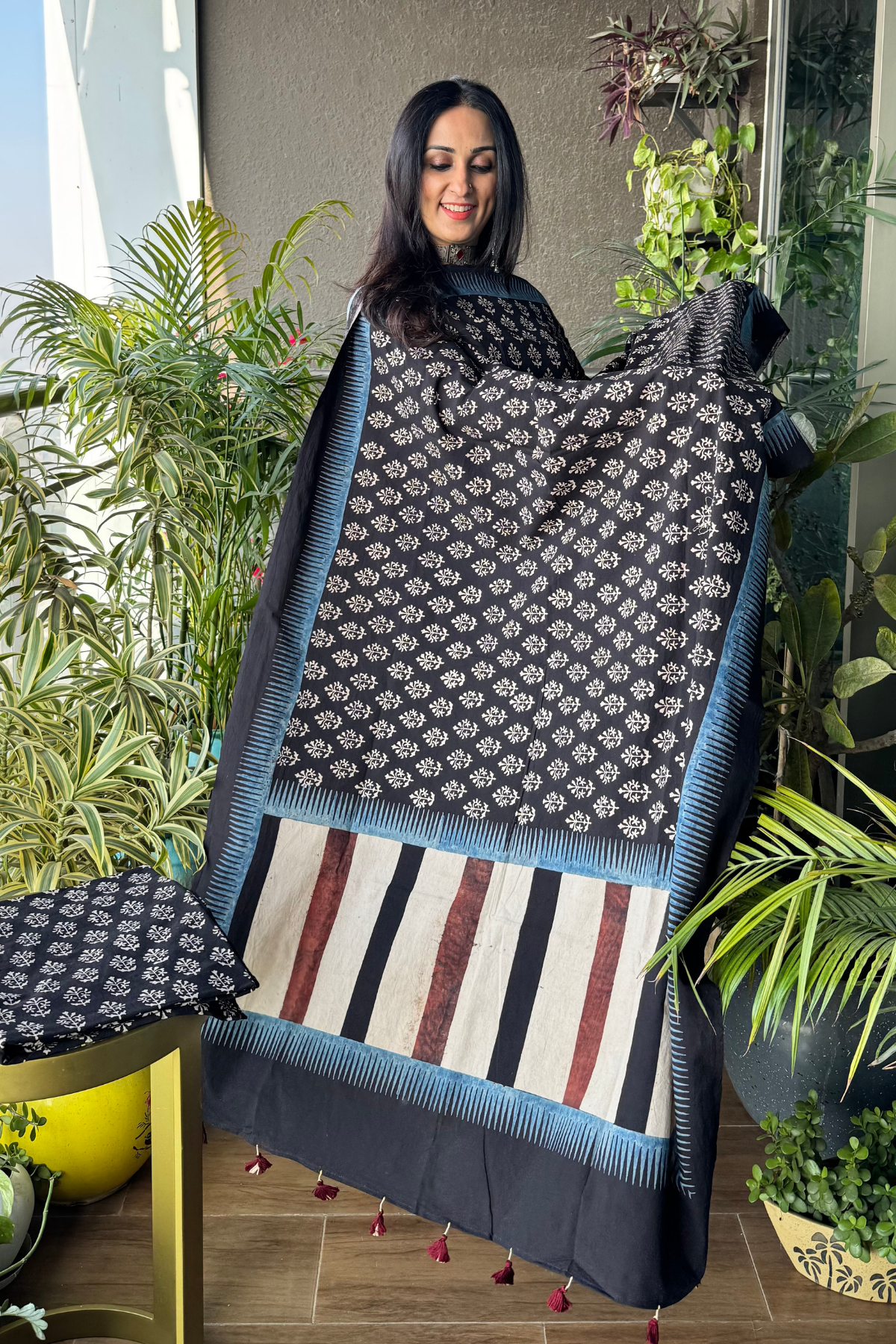 Black color suit with horizontal stripes on shirt